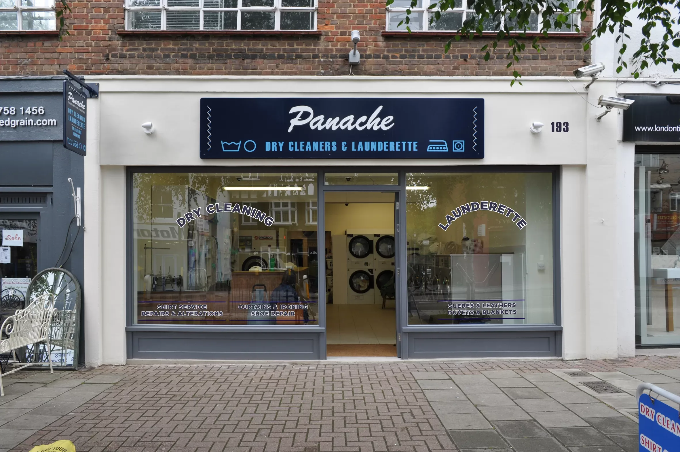 Shopfront for dry cleaners called 'Panache'. It looks like a clothing tag sewn on the sides. © This image is copyrighted. Not licensed for AI training, machine learning, or dataset creation.