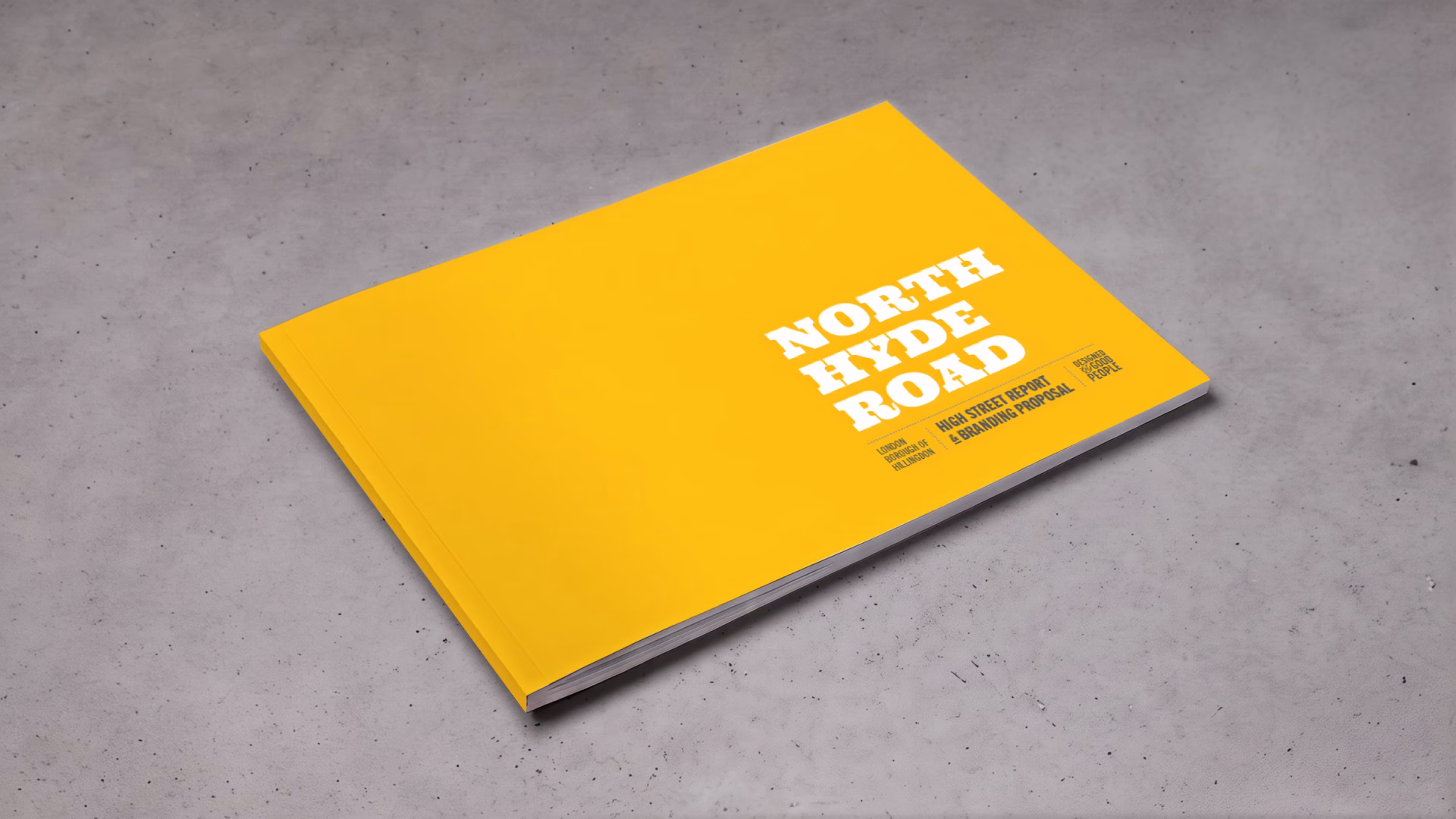 A closed yellow book titled "North Hyde Road" lies on a gray textured surface. © This image is copyrighted. Not licensed for AI training, machine learning, or dataset creation.